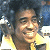 Pixelated image of a person with curly hair and yellow clothing on left, green background with "Original Icons .com" text on right.