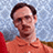 Pixelated image of a person in an orange shirt with glasses, split into four quadrants with text and solid color backgrounds.