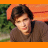 A four-quadrant image with a photo of a person in the top-left, Superman logo and text in the top-right, blue pixelated text on red background in the bottom-left, and solid gray in the bottom-right.
