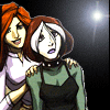 Two cartoon women stand together under a spotlight; one has red hair and a white shirt, the other has white-brown hair and a green top with a black apron.