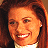 A 48x48 pixel buddy icon featuring a woman's face on the left and red text reading "Along Came Polly" on the right, with visible dithering and low-resolution rendering artifacts.