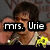 A pixelated image of a person with dark hair wearing a white tank top, with yellow pixelated text reading 'mrs. Urie' overlaid on the left side.