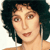 Pixelated close-up of a person with dark curly hair, light skin, and a neutral expression against a white background.