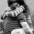 Black-and-white image of two people embracing, one wearing striped sleeves; text overlay reads "perfect couple" with heart symbols.