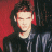 A pixelated image shows a person with dark hair against a red and black background, next to green text reading 'OriginalIcons.com' on a solid green backdrop.