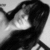 Pixelated grayscale image of a figure with dark hair and light clothing, partially obscured by motion blur or compression artifacts.