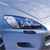 Pixelated blue vehicle with dark accents and white highlights on a light blue background, appearing as a static digital image.