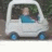 Animated sequence showing a person in a white car with blue wheels, driving past green foliage; text changes from 'PLEASE MTV' to 'PIMP MY RIDE!!'