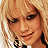 Pixelated image of a person with blonde hair and dark eye makeup, next to text reading 'Hilary Duff' and 'Rocks!' on white background.
