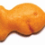 A pixelated orange fish-shaped cracker on white background, with teal and yellow adjacent containing text
