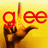 Pixelated image with yellow gradient background, red lowercase 'gee' text, and brown hand gesture pointing upward.