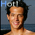 A 4-frame animated contact sheet showing a shirtless man with dark hair against a beach background, each frame displaying the word "Hot!" in blue text above his head with slight variations in facial expression and hair movement.