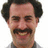 A static image with a red background, featuring a pixelated portrait of a man with dark curly hair and a mustache on the left side.