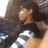 A person with long dark hair in a striped shirt appears to shift position