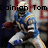 Pixelated image of a football player in blue and white uniform holding a football, with overlaid text reading "Dainian Tomast player" and "I'd say yes".