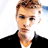 Static pixelated image of a person with light brown hair and dark eyes wearing a black jacket over a white shirt against a bright background.