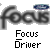 Gray background with large blurred 'focus' text, small blue oval shape above right, and pixelated black-and-white 'Focus Driver' text below.