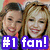Two women pose together in a pixelated image with a purple text overlay reading '#1 fan!' on the left side.
