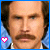 A pixelated portrait of a man with dark hair and mustache, featuring two side-by-side frames showing heart symbol animation.