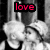 Black-and-white anime-style image of two characters kissing, with colored text overlays reading "love," "is," and "everywhere" in red, yellow, and cyan.