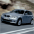Pixelated image of a silver sedan in motion on a road with blurred background elements.