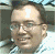 A pixelated profile image of a person with glasses and a light-colored shirt, showing two slightly different facial expressions.