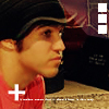 A person in a black cap and red shirt appears in profile view with a white plus sign overlay on the lower left.