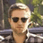 A pixelated image shows a person with light hair and sunglasses in the left portion, while the right side displays green text reading 'haircut!<3' on a white background.