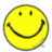 A yellow smiley face icon with black eyes and mouth on a white background, next to red pixelated text on a cyan background.
