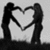 Two dark silhouettes form a heart shape with their arms against a light gray background, creating a pixelated monochrome composition.