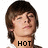 Two side-by-side pixelated images of a person with brown hair, showing text below the neck changing from 'HOT' to 'STUFF' on a white background.