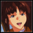 Pixelated anime-style character with brown hair and blue eyes, wearing a brown jacket over a light blue shirt, next to stylized text on a black background.