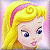 Pixelated cartoon-style icon of a blonde female character with purple eyes and pink lips, wearing a yellow dress with brown accents and a pink headband, set against a soft pink background.