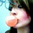 Pixelated close-up of a character with light skin, dark hair, and an orange mouth shape against a blue background.
