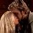 Two figures in close physical proximity with one figure's head resting on the other's shoulder, rendered in low-resolution pixelation.