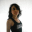A person with dark shoulder-length hair wears a black tank top with white text, positioned against a light background in four sequential views.