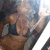 A pixelated image of a person in a black top and brown shorts, with a blurred background and visible motion blur effects.