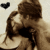 A pixelated static image shows two figures in a close embrace, one figure with dark hair and the other with lighter brown hair against a light background.