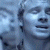 A pixelated contact sheet showing two frames of an animated icon with a blue-toned figure on the left and green text reading "Original Icons .com" on the right against a dark background.