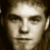 Pixelated grayscale portrait of a person with light hair against brown background, text 'marc broussard .com' in white pixel font on right.