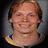 A split image shows a person with light brown hair and a yellow-trimmed dark shirt on the left, and a black sports jersey with gold number 61 on the right.