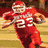 A football player in a red uniform with number 23 runs on a field, while another view shows him tackling an opponent and a trophy image appears.