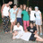 A pixelated group photo of people with orange text overlays on a black background.