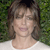 Static pixelated image of a person with brown hair against green foliage background, wearing white top, low-resolution 50x50 icon displayed at 256x256 pixels.