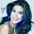 Pixelated image of a person with long dark hair wearing a sleeveless top, smiling with visible teeth, against a light blue background with a small heart symbol.