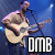 Pixelated static image of a musician playing acoustic guitar on stage with blue background and "DMB" text logo.