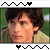 Animated contact sheet showing two frames of a pixelated character with brown hair and beige jacket against green background, bordered by black-and-white zigzag patterns with heart symbols.