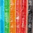 Vertical stripes of blue, green, orange, red, and black alternate in a repeating pattern with subtle pixelated texture.