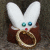 A pixelated animated buddy icon featuring a white rabbit-like creature with blue eyes and red nose holding a golden ring, next to stylized text reading "LORD PEEPS" on black background.