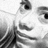 Pixelated grayscale image of a stylized character with large eyes and dark hair, partially cropped on the left side.